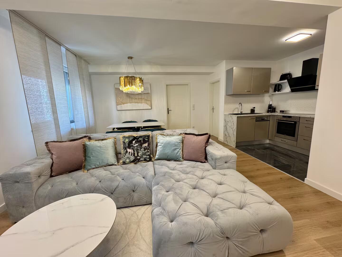 Wohnbereich mit Sofa und Küche im Familien-Apartment